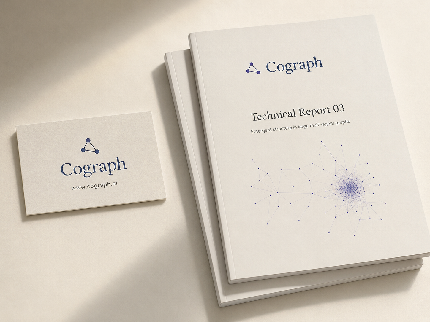 Cograph brand mockup: a letterpress business card beside a printed technical report